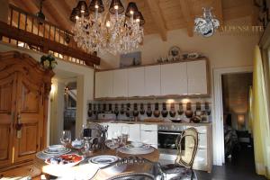 a kitchen with a table and a chandelier at Alpen-suite in Riezlern