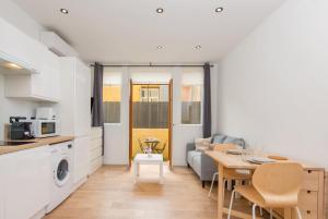 a kitchen and living room with a table and a dining room at Margot in Beausoleil