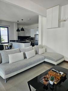 a living room with a couch and a table at Happy Villa in Choengtalay in Laguna Phuket