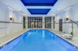 a large pool with blue water in a building at Holiday Inn Louisville Airport - Fair/Expo by IHG in Louisville