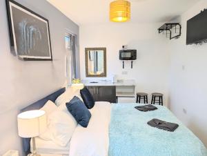 a bedroom with a bed and a white couch at Blok 3 -Jacuzzi Suites, Apartment & Ensuite Rooms in Blackpool