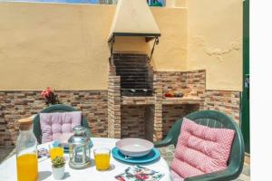 a table and chairs with a table and a fireplace at CASA CANDILES in Torrox Costa