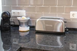 a toaster sitting on top of a kitchen counter at Villa ELTAEL - Miguel House - Warm Pool until 1 November - Facilities for disabled guests in Manta Rota +40 photos
