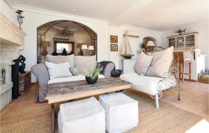 a living room with a couch and a table at Awesome Home In Les Adrets D L'estérel in St Jean de l’Esterel