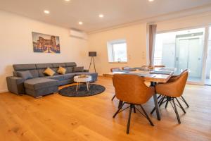 a living room with a couch and a table at FeWo Wohlleben Petrus VI in Trier