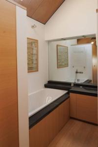 a bathroom with a bath tub and a sink at Maybell Cottage, Your Luxury Seaside Pad in Pittenweem +15 photos