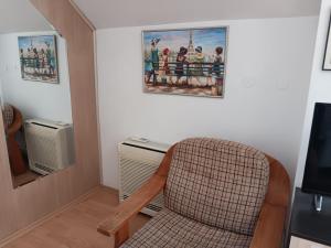 a chair in a room with a picture on the wall at Central Park Studio in Plovdiv