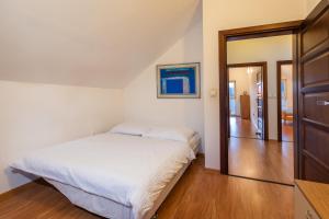 a bedroom with a bed and a sliding glass door at Private holiday house Vivendi in Liptovský Mikuláš