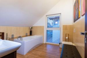 a large bathroom with a tub and a sink at Private holiday house Vivendi in Liptovský Mikuláš