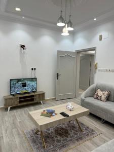 a living room with a couch and a coffee table at نزل العلا in AlUla +9 photos