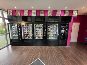 a row of soda machines in a store at Candy Vibe Inn in Nuremberg +23 photos