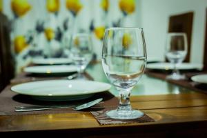a wine glass sitting on top of a table at Nethu Villa Dodanduwa in Dodanduwa