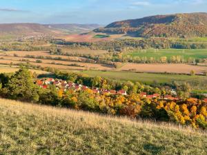 an autumn view of a village in the hills at Ferienwohnung im Himmelreich in Jena