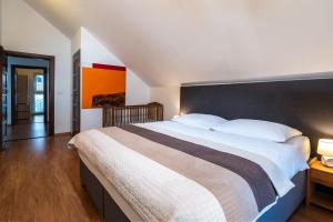 a bedroom with a large bed with a black headboard at Private holiday house Vivendi in Liptovský Mikuláš