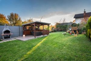 a backyard with a gazebo and a playground at Private holiday house Vivendi in Liptovský Mikuláš