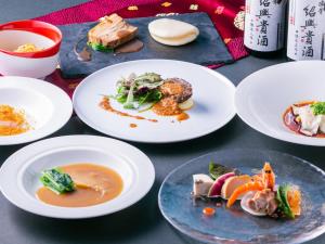a group of plates of food on a table at Hotel New Otani Saga in Saga