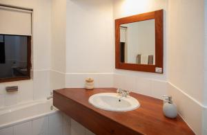 a bathroom with a sink and a mirror and a tub at Heuglins Lodge in White River +67 photos
