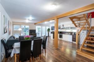 a dining room and living room with a table and chairs at Private holiday house Vivendi in Liptovský Mikuláš