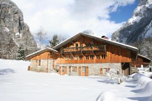 ein Chalet in den Bergen im Schnee in der Unterkunft La ferme des Fontany in Samoëns