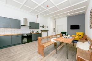 a kitchen with a table and a dining room at No 27 Liverpool in Liverpool