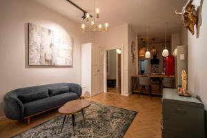 a living room with a couch and a table at OIQIA • Tolosa in Toulouse +15 photos