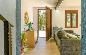 a living room with a couch and an open door at 4 Bedroom Gorgeous Home In Lousame in Lousame