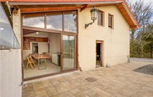 a house with large glass windows and a patio at 4 Bedroom Gorgeous Home In Lousame in Lousame +21 photos