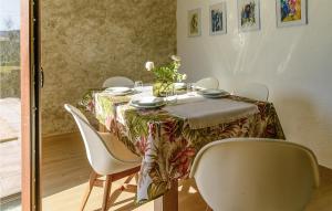 a dining room table with chairs and a table cloth at 4 Bedroom Gorgeous Home In Lousame in Lousame