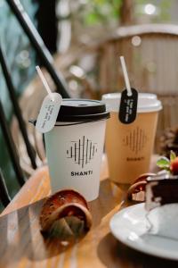 a table with two cups of coffee and a pastry at Shanti-Retreat Hotel in Pua