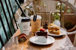 a table with two plates of desserts and two cups of coffee at Shanti-Retreat Hotel in Pua