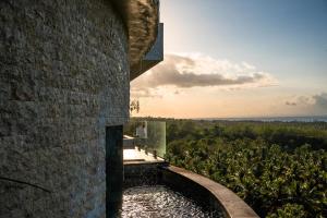 a view from the side of a building looking out over a forest at Villa Kalliste in Nusa Penida +9 photos