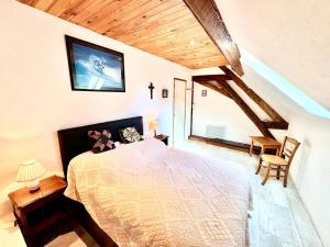 a bedroom with a large bed in a attic at Maison d'Antan, Ambiance chevaleresque Cave voutée in Saint Laurent Nouan