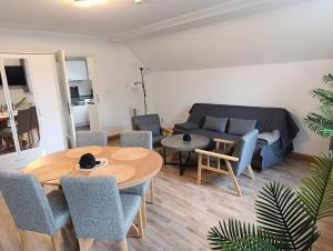 a living room with a couch and a table and chairs at Ferien- Monteurwohnung bis 6 Personen in Markranstädt