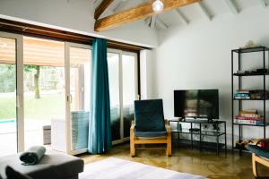 a living room with a couch and a tv and a chair at Casa da Assudra in Vila Verde