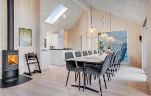 a dining room with a table and a fireplace at Awesome Home In Sydals With Sauna in Sarup