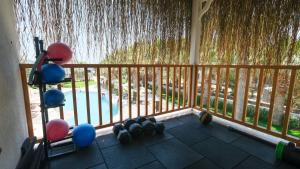 a balcony with dumbbells and a fence with a waterfall at Regia Mare Beach Hotel & Spa Bodrum in Ortakent