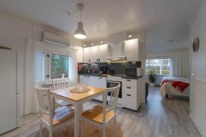 a kitchen and dining room with a table and chairs at Riverhouse studio in Ivalo