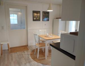 a kitchen with a table and chairs in a kitchen at Riverhouse studio in Ivalo