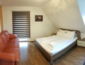a bedroom with a bed and a couch at Ferienwohnung Michelle mit Balkon für 1 - 6 Personen in Warmensteinach