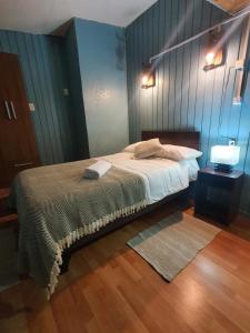 En eller flere senge i et værelse på Hostal El Baltico