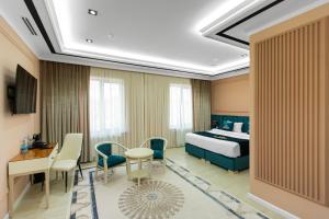 a hotel room with a bed and a desk at HOTEL SULTAN PALACE in Samarkand