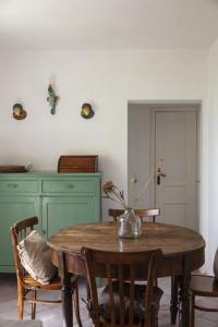 a dining room table with a vase of flowers on it at Villa Lindo in Maiori
