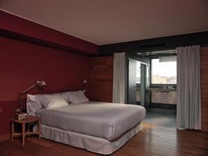 a bedroom with a large bed and a large window at Casa Camper Berlin in Berlin
