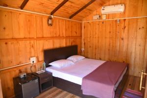 a bedroom with a bed in a wooden room at Club Palolem Resort in Palolem +80 photos