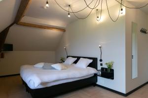 Una cama o camas en una habitación de 't Convent