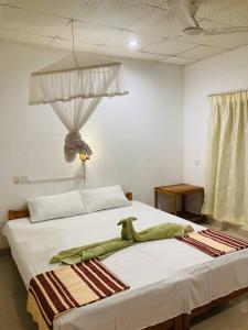 Postel nebo postele na pokoji v ubytování Sigiri Lodge