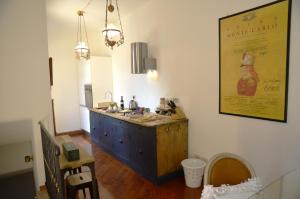 a kitchen with a wooden island in a room at La piccola corte in Ravenna