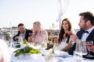 a group of people sitting at a table with wine glasses at Pytloun Boutique Hotel Prague in Prague
