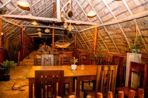a dining room with a table and a dog laying on the floor at Villa Senu in Hiriketiya