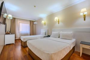 A bed or beds in a room at Peak Star Hotel